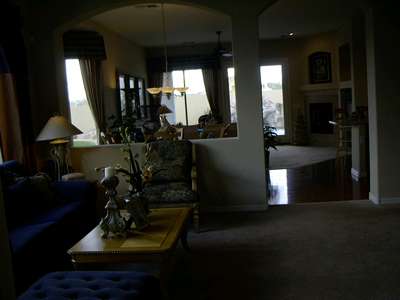 View standing in the foyer looking into the sitting room and into the rest of the house. Sorry it came out so dark, that's what happens when you have lots of sun light coming in.